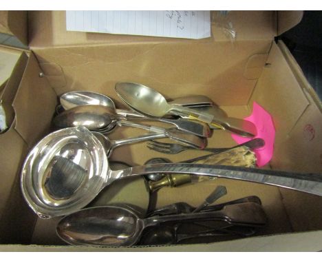 A box containing silver plated flatware including a ladle, serving spoons, Waratah silver serving spoons and a magnifying gla