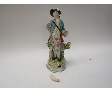 An early 19th Century porcelain figure of a gentleman in tricorn hat with dog (a/f).  A Moore ceramic oil lamp applied with p
