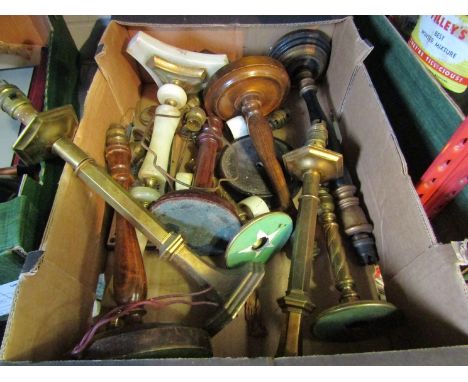 A box containing various lamp bases including brass and wooden examples 