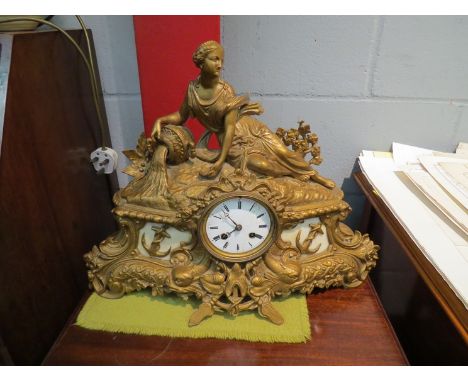 A 19th Century gilt spelter mantel clock, the top surmounted by a maiden over a Naval design base, Roman numerated dial a/f