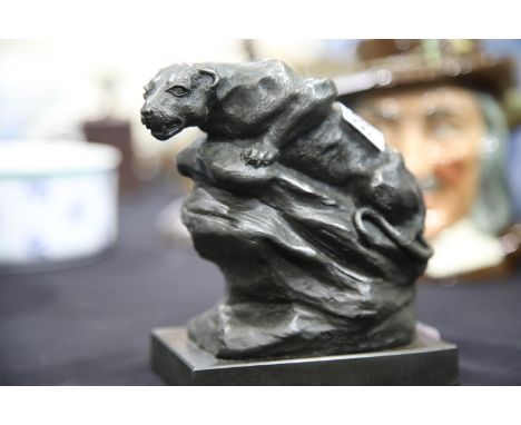 Cast leopard crouching on a rock after John Macallan Swan. P&amp;P Group 2 (£18+VAT for the first lot and £3+VAT for subseque