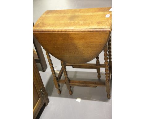 Small oak drop leaf table raised on bobbin supports. Not available for in-house P&amp;P. 