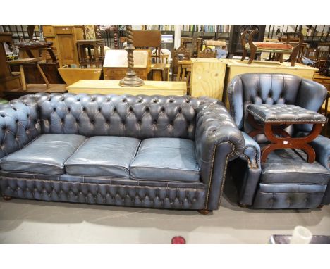 Contemporary blue leather Chesterfield style three seater sofa bed, wing back reclining armchair and a savonarola framed stoo