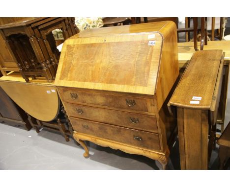 Art Deco walnut fall front bureau, the fitted interior sita above a base of three long drawers. Not available for in-house P&