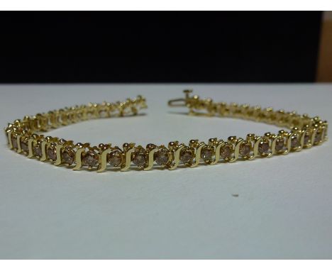 3 carat diamond bracelet stamped 10ct gold, diamond colour champange clarity si, size 7 1/4 inch approx. Condition report: it