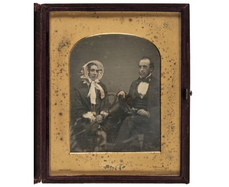 * Daguerreotype. Large half-plate daguerreotype of a husband and wife seated together, photographed by Cornelius Jabez Hughes