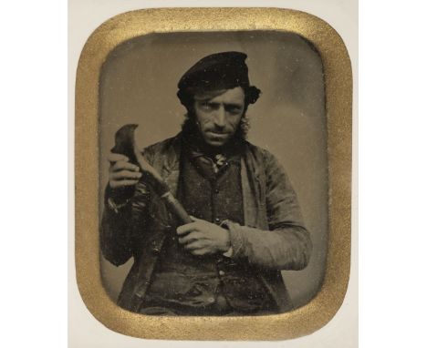 * Ambrotype. Sixth-plate ambrotype of a carpenter holding a billhook, c. 1860, ornamental gilded frameQTY: (1)