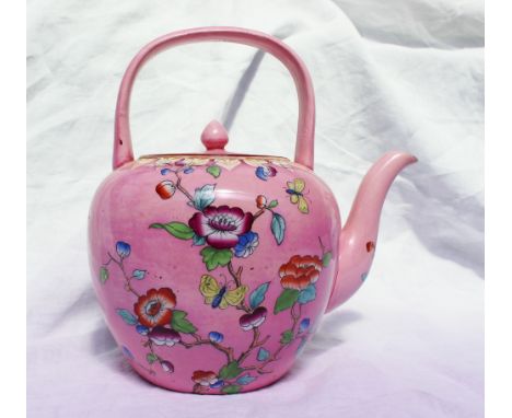 A Victorian Beech Hancock & Co teapot with a looped handle over the circular finial topped cover and ovoid body with petal mo