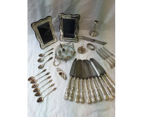 A pair of Elizabeth II silver photograph frames, Birmingham, 1996, together with silver handled knives, a silver desk candles