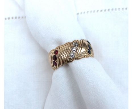 A ruby, diamond and sapphire ring set with three bands of sapphires, rubies and diamonds to a yellow metal band, approximatel