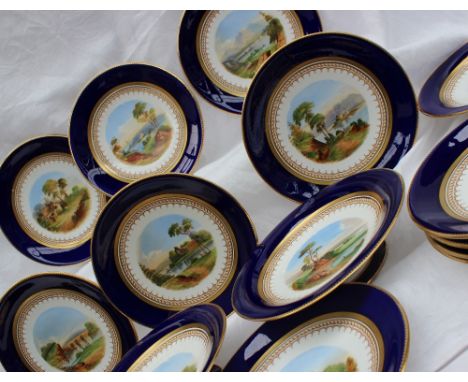 A 19th century porcelain dessert set each piece painted with landscape scenes within a Royal blue border with gilt highlights