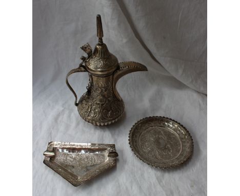 A white metal teapot, with a domed pointed lid, the body embossed with leaves and flowers, stamped 'Silver' to the base, insc