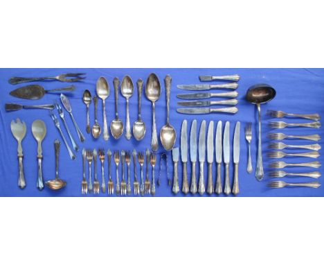 A continental white metal part flatware service, comprising a ladle, two large serving spoons, four table spoons, twelve cake