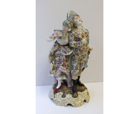 A Richard Eckert & Co. porcelain figure group of a lady and gentleman; the gentleman leaning on a walking stick, the lady hol