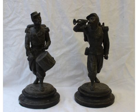 After Guillemin - a pair of spelter figures of soldiers, one playing a drum, the other a bugle, on turned wooden bases, overa