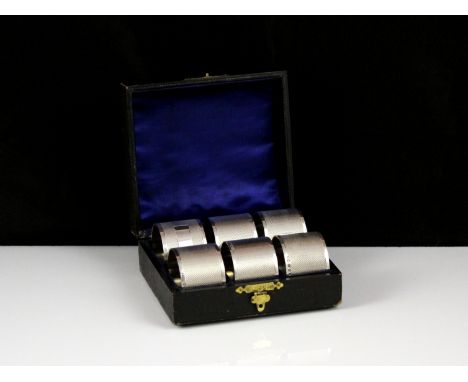 A set of six Elizabeth II Sterling Silver napkin rings by Preece & Williscombe, London 1966. With engine turned decoration an