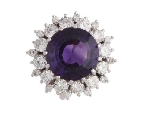 A magnificent amethyst and diamond cluster dress ring in white gold or platinum, the large, central round cut amethyst surrou