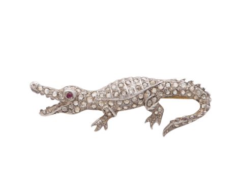An antique jewelled crocodile brooch in yellow gold and platinum / silver, modeled as a crocodile in motion with its mouth op
