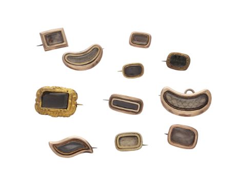 A collection of eleven antique Georgian and later mourning brooches in gold and gilt metal, of various forms including rectan