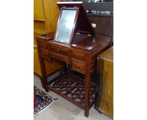 A Chinese hardwood dressing table in Chippendale style, having a sliding and raising mirrored top, drawers under, W72cm, H81c