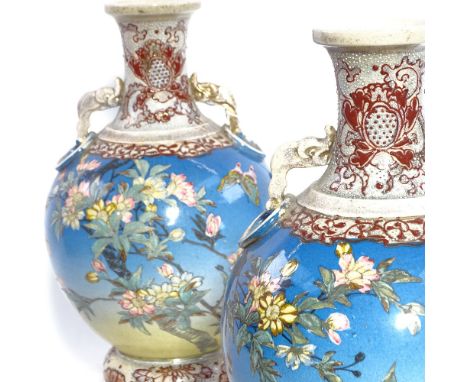 A pair of Japanese pottery vases, with painted blossom, and tripod support, 34cm 