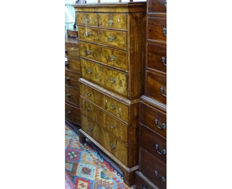 An 18th century figured walnut chest on chest, having 2 short and 6 further cross-banded long drawers, on bracket feet, W110c