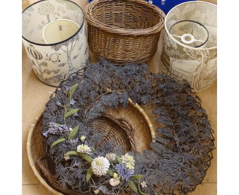 Group of wicker baskets, beadwork floral design wall ornament, and lamp shades 