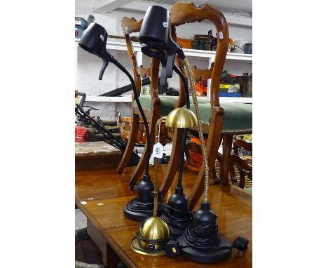 A pair of black reading lamps, a similar black and brass-effect lamp, and another (4) 