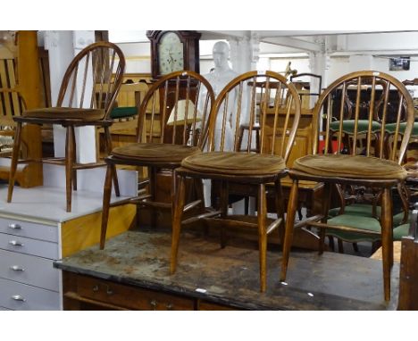 A set of 4 Ercol arch-top stick-back chairs 