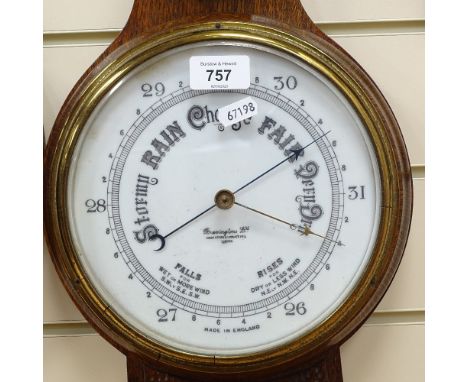 A carved oak-cased aneroid barometer and thermometer, by Brevingtons of London, with ceramic dials, height 74cm 
