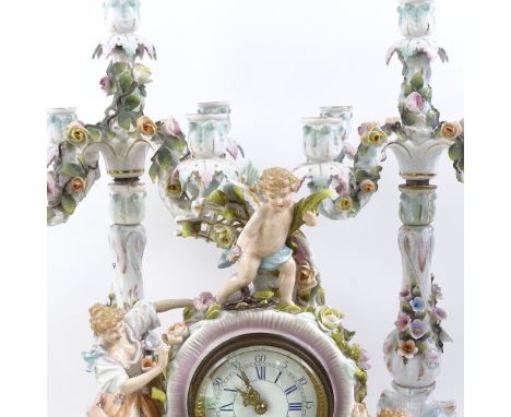 A late 19th century German Schierholz porcelain 3-piece clock garniture, movement by Lenzkirch, with cherub and figural mount