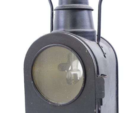 A large black painted railway oil lantern, double-sided glass panels, with carrying handle, overall height 57cm 