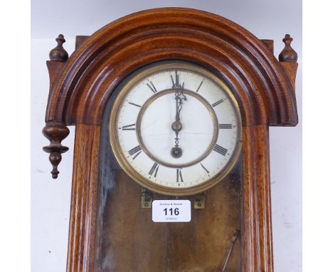 A 19th century oak-case drop-dial wall clock, white enamel dial with Roman numeral hour markers, and oval case, case height 6