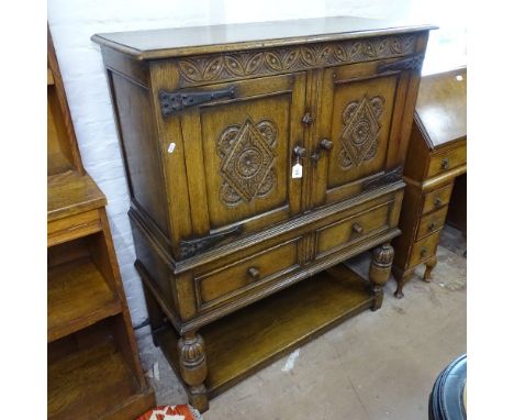 A Titchmarsh &amp; Goodwin Ipswich oak side cabinet, with 2 panelled doors, drawers under with shelf below, chip carved decor