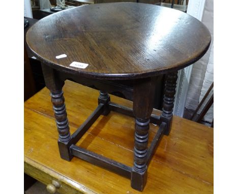 A circular oak lamp table on turned legs, W53cm, H50cm 
