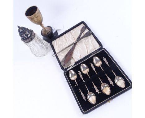 A cased set of 6 silver Apostle-ended coffee spoons, small silver trophy, sugar sifter with silver mount, and silver-handled 