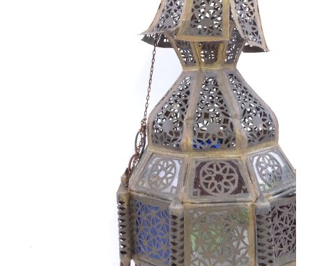 A Moroccan pierced brass lantern with coloured glass panels, height 50cm 