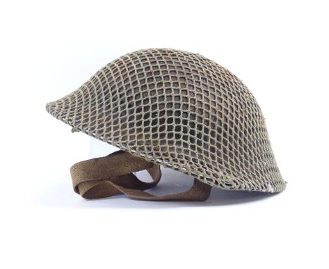 A Second War Period British Army Brodie steel helmet, with original Commando mesh webbing and canvas chin strap, internal mea