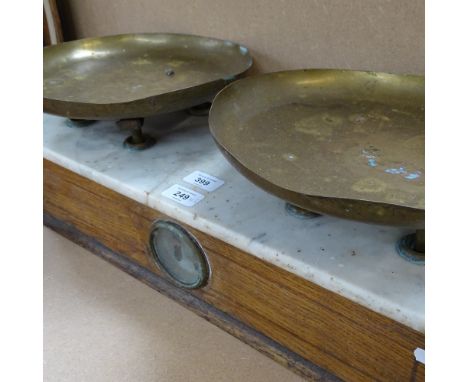 An Antique set of scales, stamped brass plates with white marble top and oak case, case length 57cm 