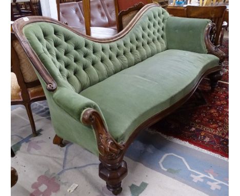A early 19th century mahogany-framed button-back upholstered settee, with carved mahogany show-wood, on heavy turned legs (po