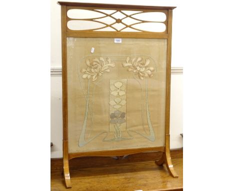 An Art Nouveau mahogany and satinwood-strung firescreen, stylised form with an inset silk work panel, W63cm, H90cm 