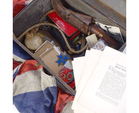 A box containing a Union Jack, photographic wartime prints, knife in scabbard, frames, badges etc 