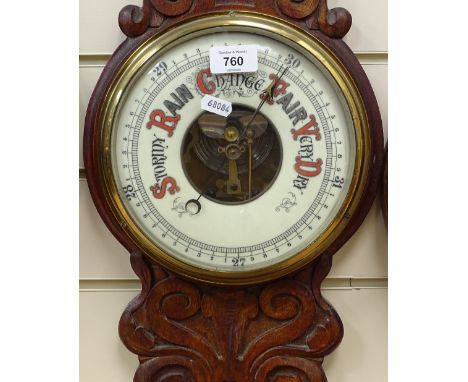 A Victorian carved oak-cased aneroid wall barometer and thermometer, with ceramic dials, height 80cm 