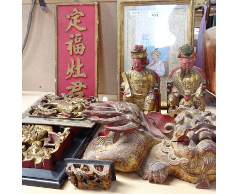 A group of Chinese carved and painted giltwood ornaments, including a Dog of Fo, length 29cm, a pair of seated figures, heigh