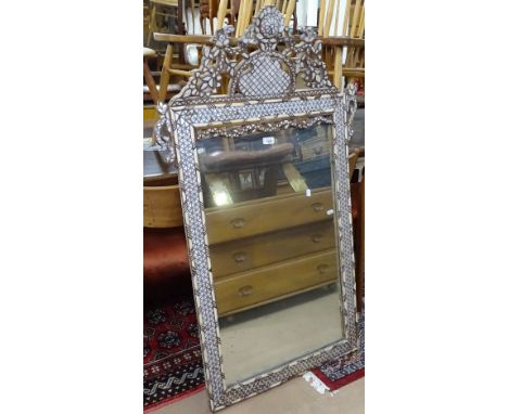 A Lebanese design mother-of-pearl and bone inlaid wall mirror, with a shaped raised pediment, W77cm, H128cm