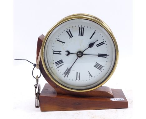 An English month running brass-cased clock with sweep second hand, with keys, height 17cm 