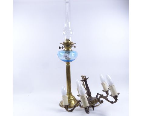 A brass oil lamp with blue glass font, and a 5-branch hanging chandelier, lamp height excluding chimney 47cm (2) 