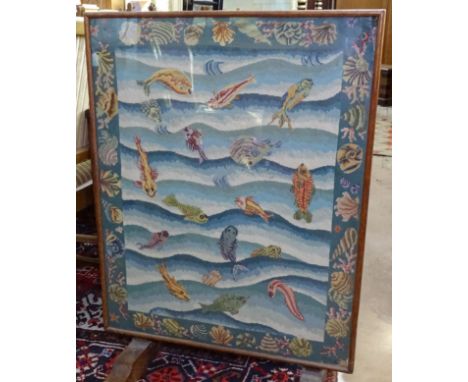 A limed oak-framed folding firescreen, with an inset needlework panel decorated with fish and shells, W63cm 