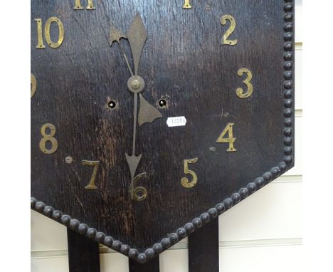 An Arts and Crafts oak hexagonal wall clock, beaded edge with picket design drop, with key and pendulum, overall case height 
