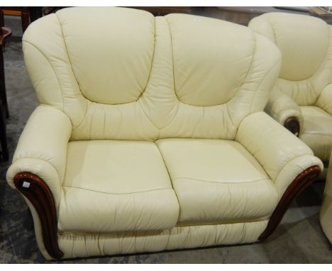 Three piece leatherette suite comprising two seater sofa and a pair of matching armchairs 